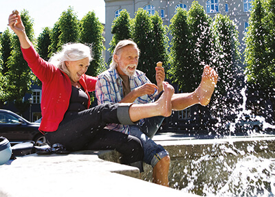 Healthy couple kicking in a fountain