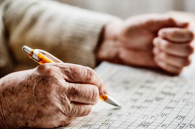Elderly person doing puzzles to keep an active mind